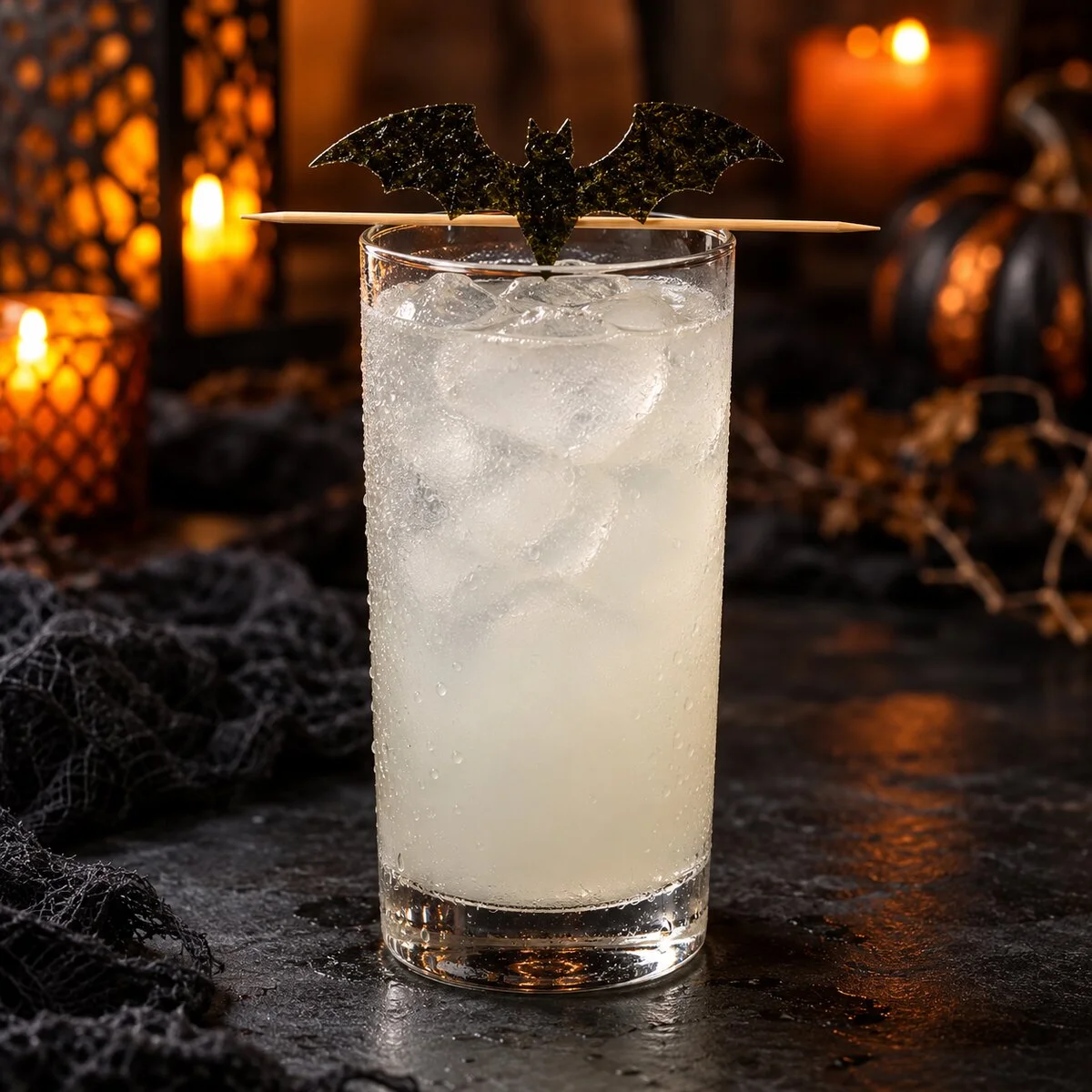 Cloudy nigori sake highball with a crisp nori bat garnish held above the glass