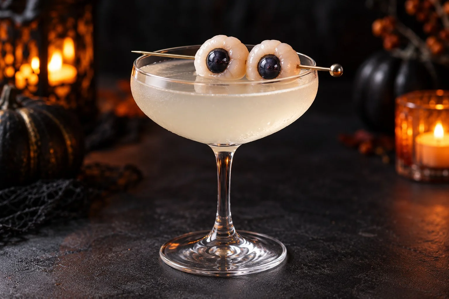 Pale lychee martini with two blueberry-stuffed lychees shaped like edible eyeballs