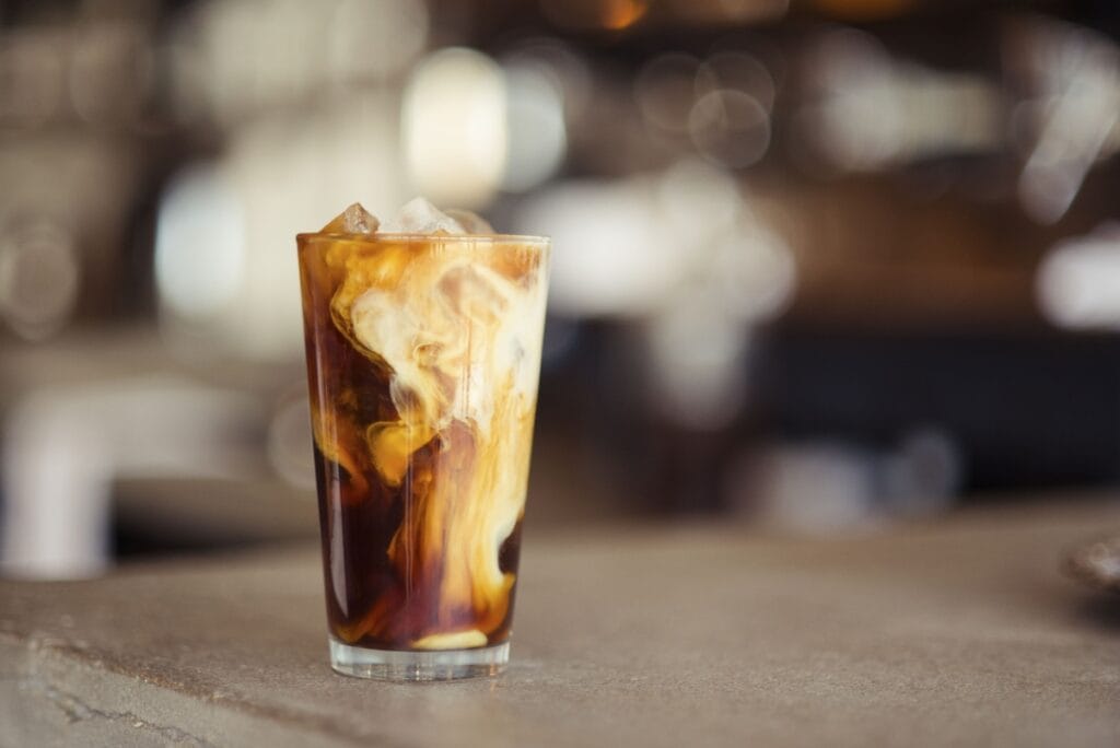 Campout Cold Brew (Dutch Bros Copycat) in a glass with milk swirling in