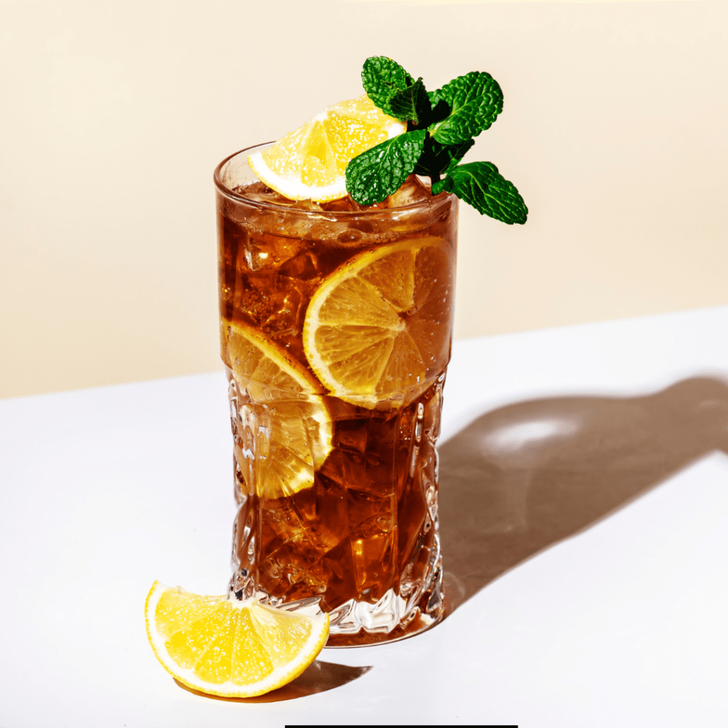 Refreshing Tea Bag Cocktail served with lemon slices and mint.