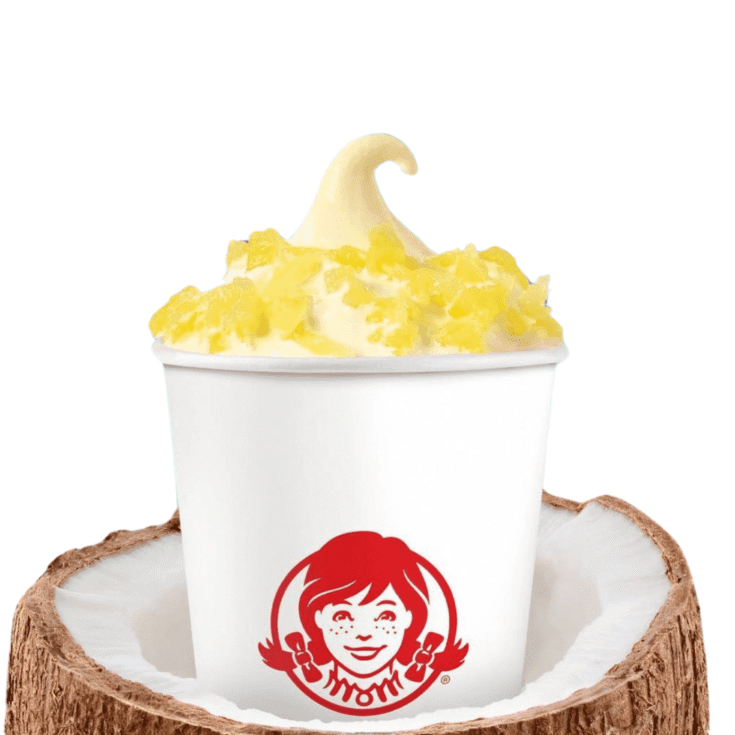 Wendy's Pineapple Frosty with whipped with pineapple toppings served on a coconut