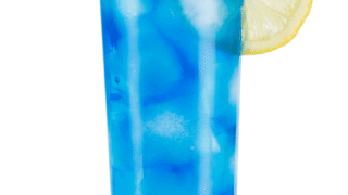 Homemade Sunkist Blueberry Lemonade served with ice cubes and lemon slice.